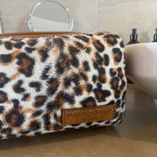 Load image into Gallery viewer, The perfect toiletry bag for those weekend getaways, short holidays, or outdoor adventures. This genuine leather toiletry bag is made from the best quality leopard print material, with a water-resistant lining. The vintage design and leather details create an authentic look and feel while giving you the durability you need in a product like this, which is likely to be used regularly.