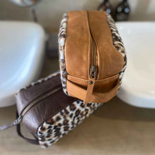 Load image into Gallery viewer, The perfect toiletry bag for those weekend getaways, short holidays, or outdoor adventures. This genuine leather toiletry bag is made from the best quality leopard print material, with a water-resistant lining.  The vintage design and leather details create an authentic look and feel while giving you the durability you need in a product like this, which is likely to be used regularly.
