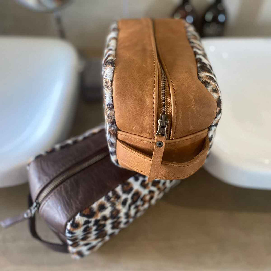 The perfect toiletry bag for those weekend getaways, short holidays, or outdoor adventures. This genuine leather toiletry bag is made from the best quality leopard print material, with a water-resistant lining.  The vintage design and leather details create an authentic look and feel while giving you the durability you need in a product like this, which is likely to be used regularly.