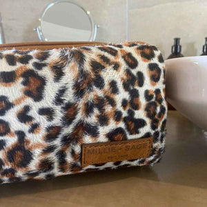 The perfect toiletry bag for those weekend getaways, short holidays, or outdoor adventures. This genuine leather toiletry bag is made from the best quality leopard print material, with a water-resistant lining.  The vintage design and leather details create an authentic look and feel while giving you the durability you need in a product like this, which is likely to be used regularly.