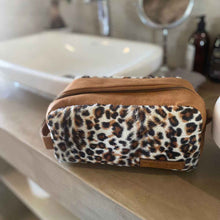 Load image into Gallery viewer, The perfect toiletry bag for those weekend getaways, short holidays, or outdoor adventures. This genuine leather toiletry bag is made from the best quality leopard print material, with a water-resistant lining.  The vintage design and leather details create an authentic look and feel while giving you the durability you need in a product like this, which is likely to be used regularly.
